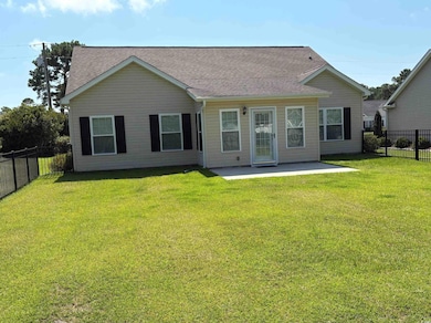 Back of property featuring a patio, a fenced backyard, and a shingled roof
