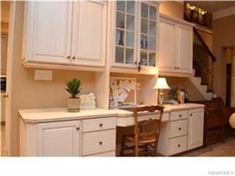On the opposite wall, a built-in desk is a conveni