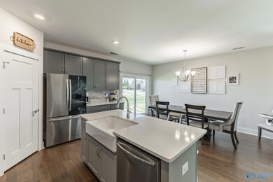 Island offers casual dining and room for a large 8 person table in chairs all on beautiful hardwood floors