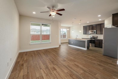 Kitchen with dark wood-style flooring, stainless 