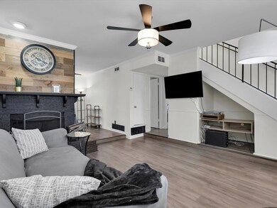 Living room with crown molding, ceiling fan, a fir
