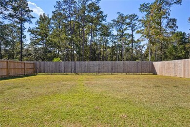 Large fenced rear yard backing to woods