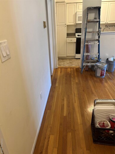 Kitchen with dark wood finished floors, range, and dark countertops