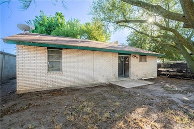 Rear view of house with brick siding and a patio area