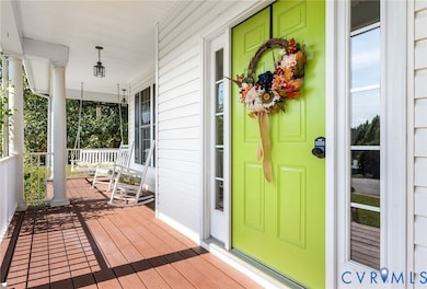 Entrance to property featuring covered porch