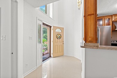 Foyer entrance featuring a textured ceiling and light tile patterned floors