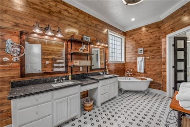 Full bath with vanity, crown molding, wooden walls