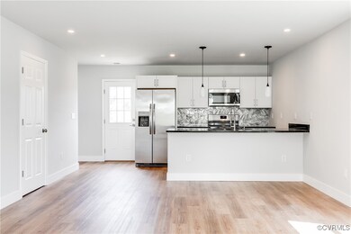 Kitchen with stainless steel appliances, dark coun