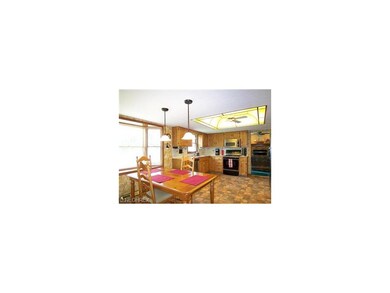 Open Kitchen with Casual Dining Area and Bow Windo