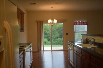 View of dining area to patio and peaceful wooded v