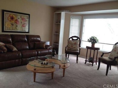 This large living room has a wall of windows to le