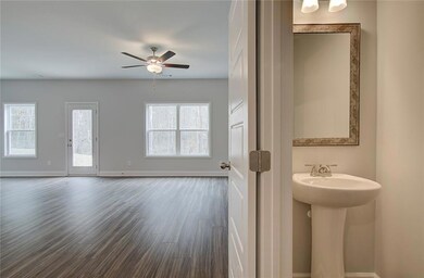 Half bathroom with dark wood-style floors and ceiling fan