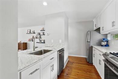 Kitchen features custom cabinetry, granite counter