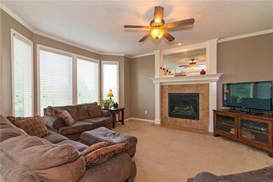The great room highlights a cozy fireplace, wide c