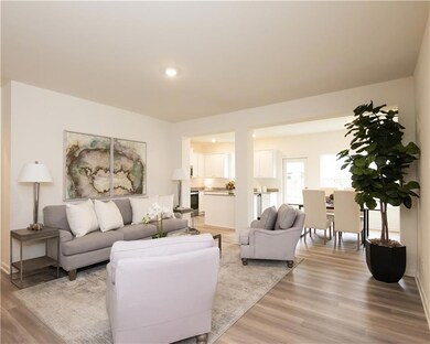 Living area featuring light wood-style floors and recessed lighting