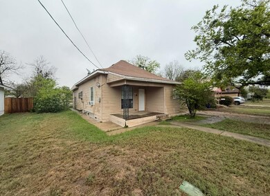 Bungalow with fence and a front lawn