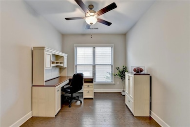 Home office featuring dark hardwood / wood-style f