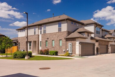 Townhome / multi-family property featuring a gara