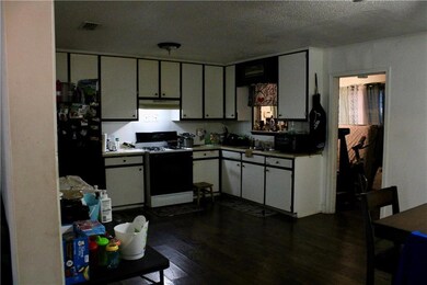 Kitchen featuring gas range, freestanding refriger