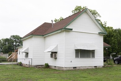 View of side of property with a lawn
