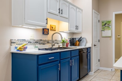 Kitchen with white cabinetry, dishwasher, sink, bl