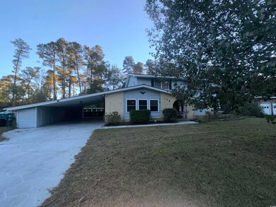 View of front property featuring a carport and a f