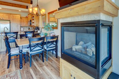 Dining room featuring light wood-style floors, beam ceiling, a chandelier, and recessed lighting