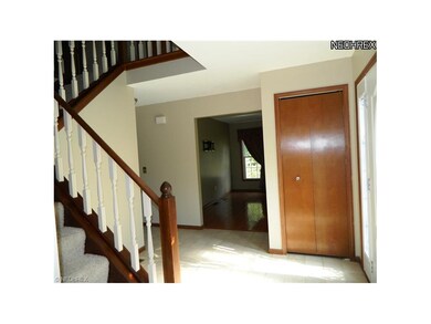 Ceramic tiled foyer with turned staircase, flanked