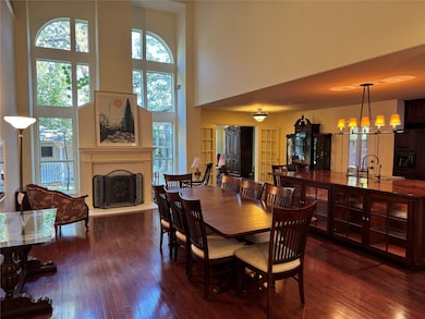 The main living room is being used for dining currently and has incredible views of the lovely backyard