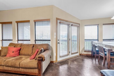 Living room with baseboards and concrete floors