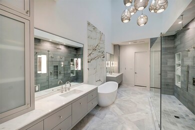 This primary suite's en-suite bathroom showcases l