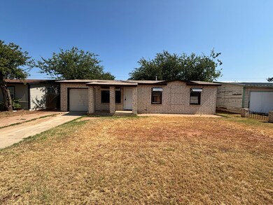 Ranch-style home with a garage and a front lawn