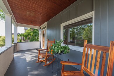 Stunning covered front porch with original hardwoo