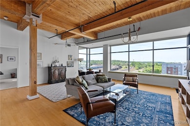 Open concept living area with massive floor to cei