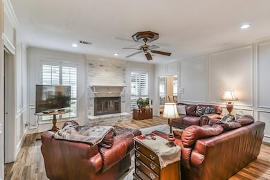 Large open living room with redesigned brick gas fireplace and mantle piece. New wood floors throughout the first floor. Authentic Ash wood paneling with wainscotting detail!