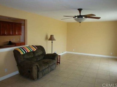 Living room w/ view of kitchen in back