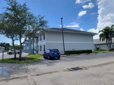 View of side of property with uncovered parking and stucco siding