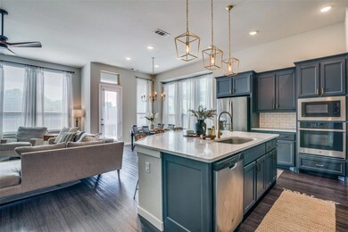 Kitchen featuring tastful backsplash, stainless steel appliances, gas cooktop, and an island with sink