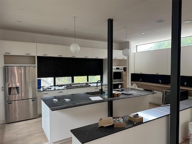 Kitchen featuring stainless steel appliances, whi