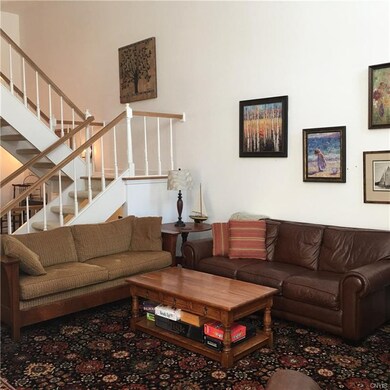 Living room with open stairway to 2nd floor.