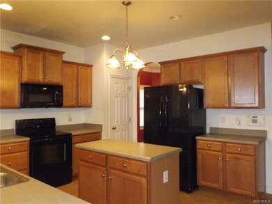 The kitchen has recessed lighting, a center island and plenty of cabinet space.  It opens to a large breakfast room and also to the family room.