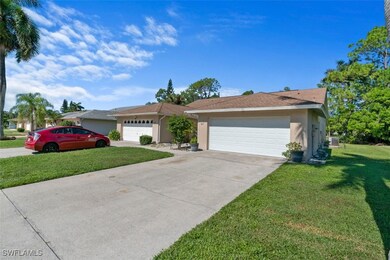 Ranch-style house with a front yard, a detached ga