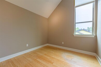 Empty room featuring wood finished floors and lof