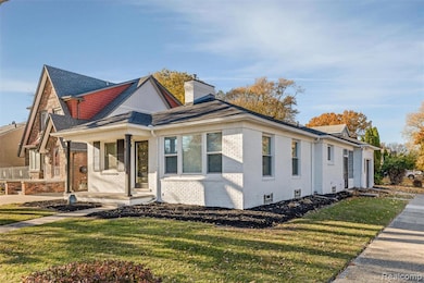 View of front of property featuring covered porch, a front lawn, brick siding, and a chimney