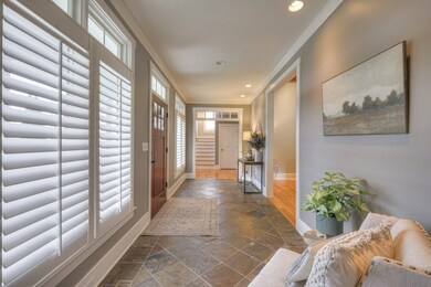 As you walk through the front door, you will be greeted by this welcoming entryway with its slate tile floors and transom windows. Enjoy plantation shutters throughout the home.