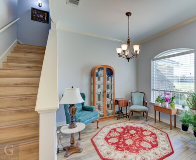 Dinning  room with crown molding, wood-type floori