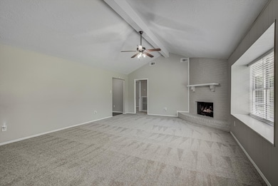 This spacious living room features a vaulted ceili