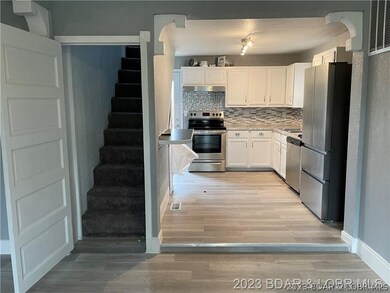 Kitchen and stairs to upper level
