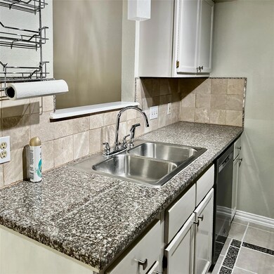 Kitchen featuring dishwasher, baseboards, white c
