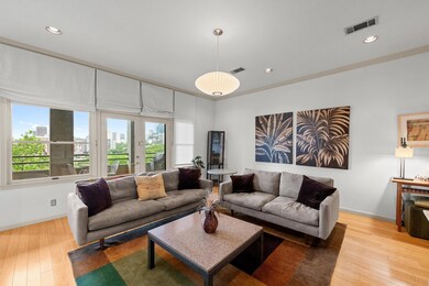 Living area with baseboards, wood finished floors